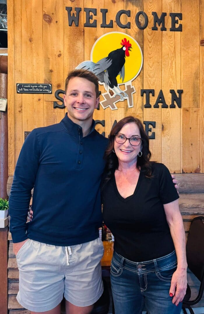 Two people smiling in a cafe.