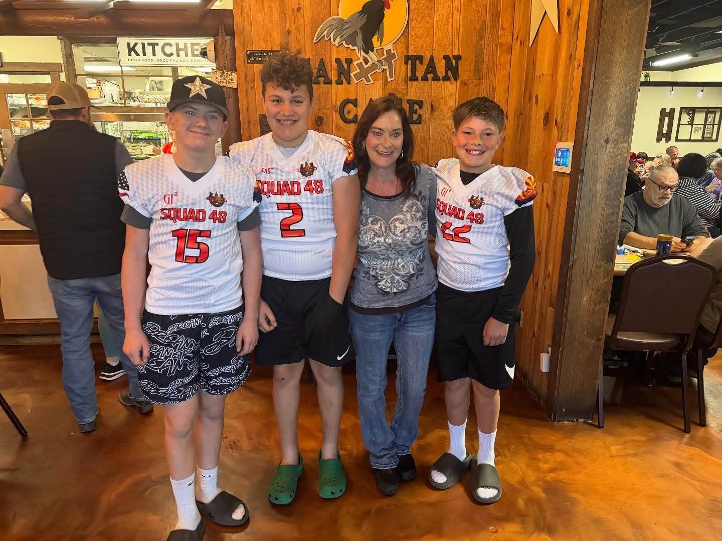 Four people posing in a restaurant.